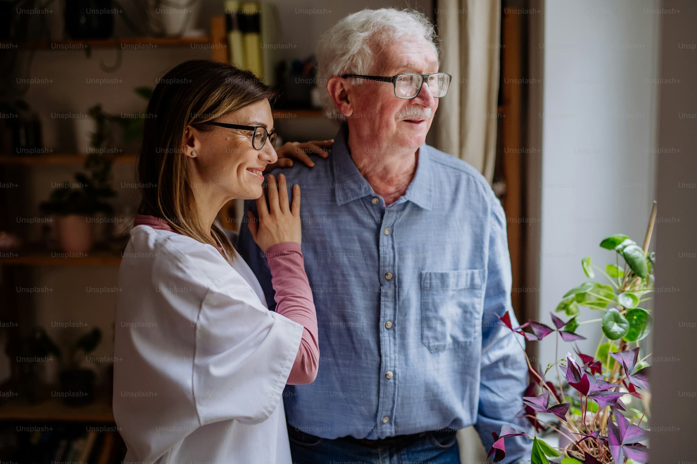 Care professional having a warm, reassuring conversation with a guest in a sunlit home